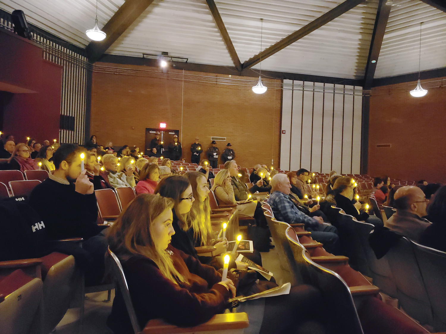 The Prout School community holds candles during Mothers Against Drunk Driving of Rhode Island’s 36th annual candlelight vigil in memory of those killed from impaired driving.